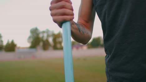 Close-up:-Hand-a-Male-athlete-at-the-stadium-takes-a-javelin-for-throwing-and-prepares-to-make-a-throw.-Goes-takes-the-spear.-Training-of-a-javelin-thrower
